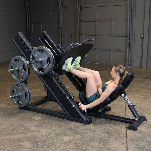Athlete using a Body-Solid SGLP500 leg press with feet flat on the footplate and back supported by the seat.