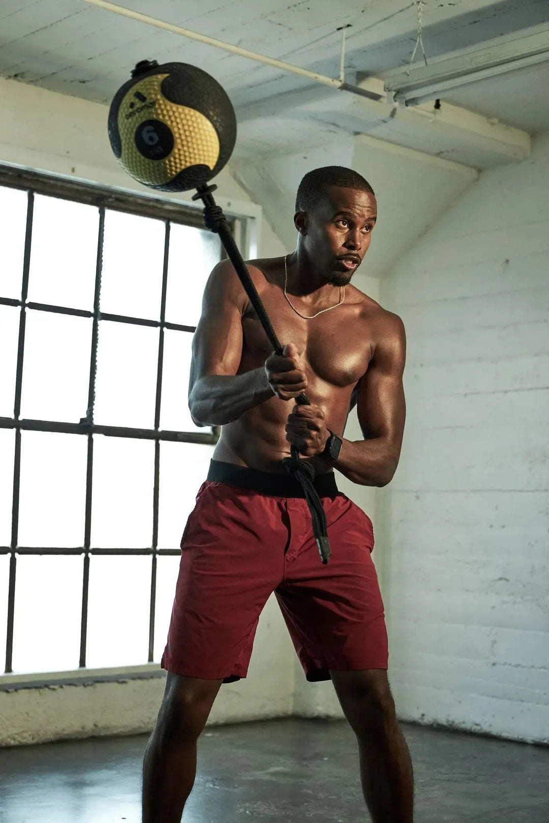 man swinging and slamming the AeroMat Rope Medicine Ball