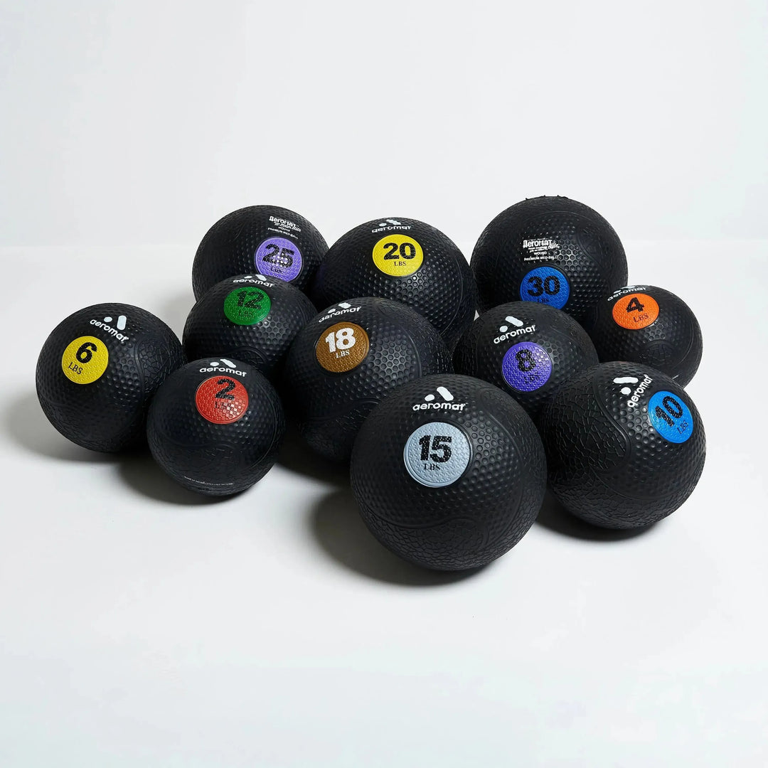Aeromat Medicine Balls in 2, 4, 6, 8, 10, 12, 15, 18, 20, 25, 30 lbs shown together.