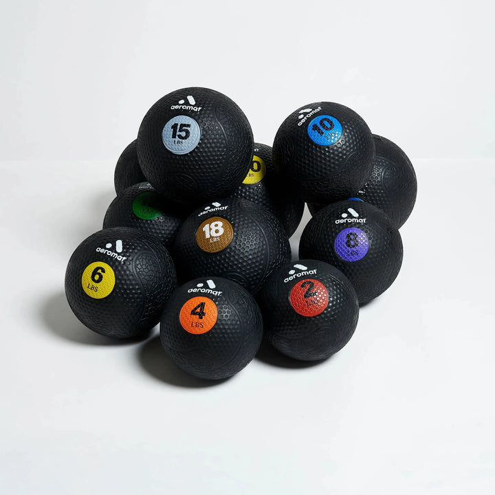 Aeromat Medicine Balls in 2, 4, 6, 8, 10, 12, 15, 18, 20, 25, 30 lbs shown together.