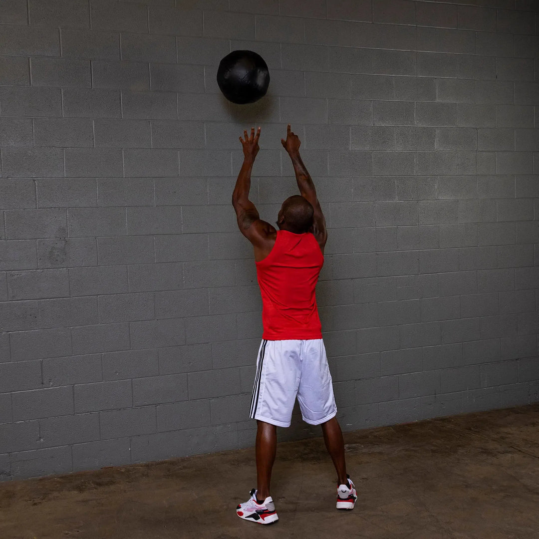man tossing Body-Solid Dynamax Wall Ball BSTDYN