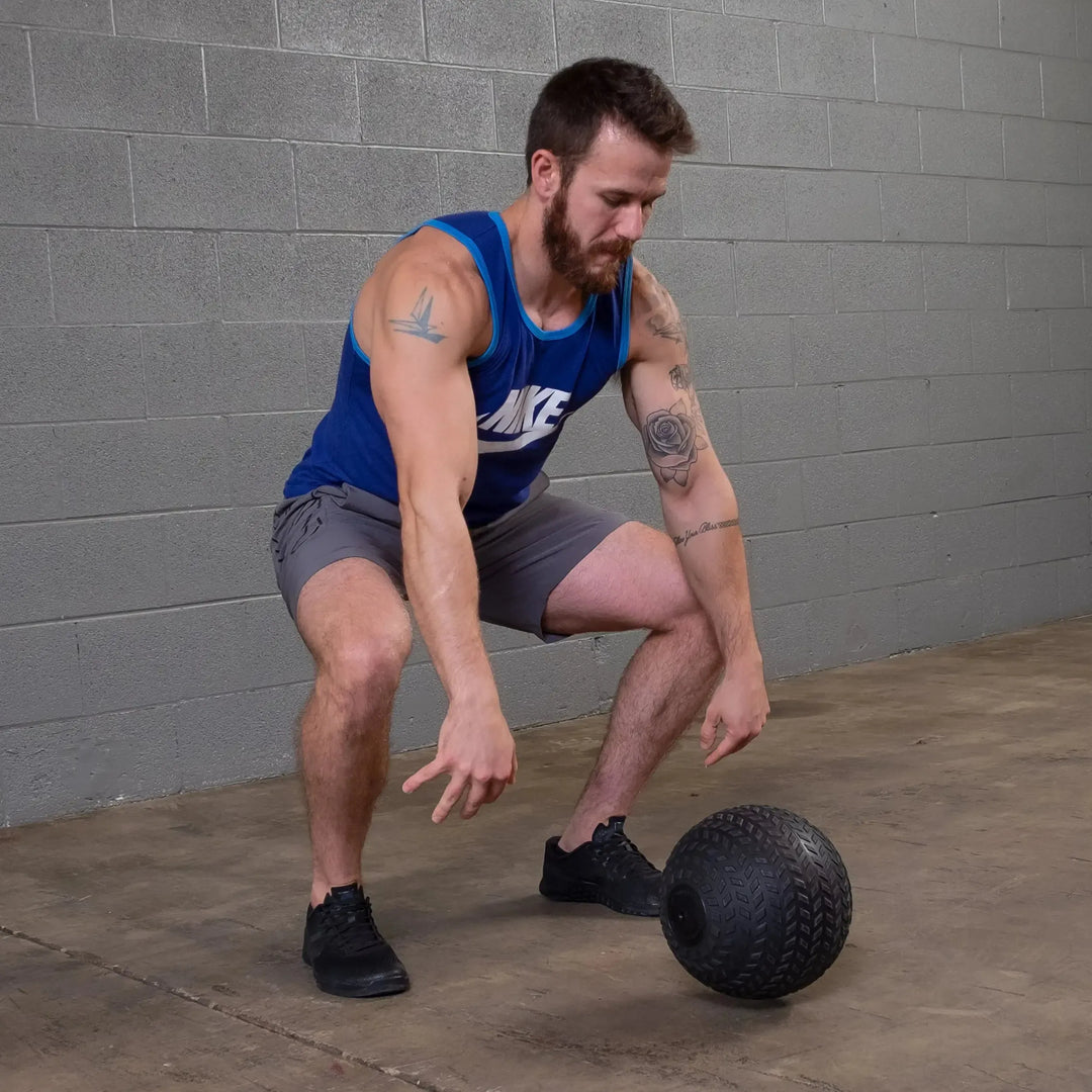 man slamming the Body-Solid Tire Tread Slam Ball BSTTT