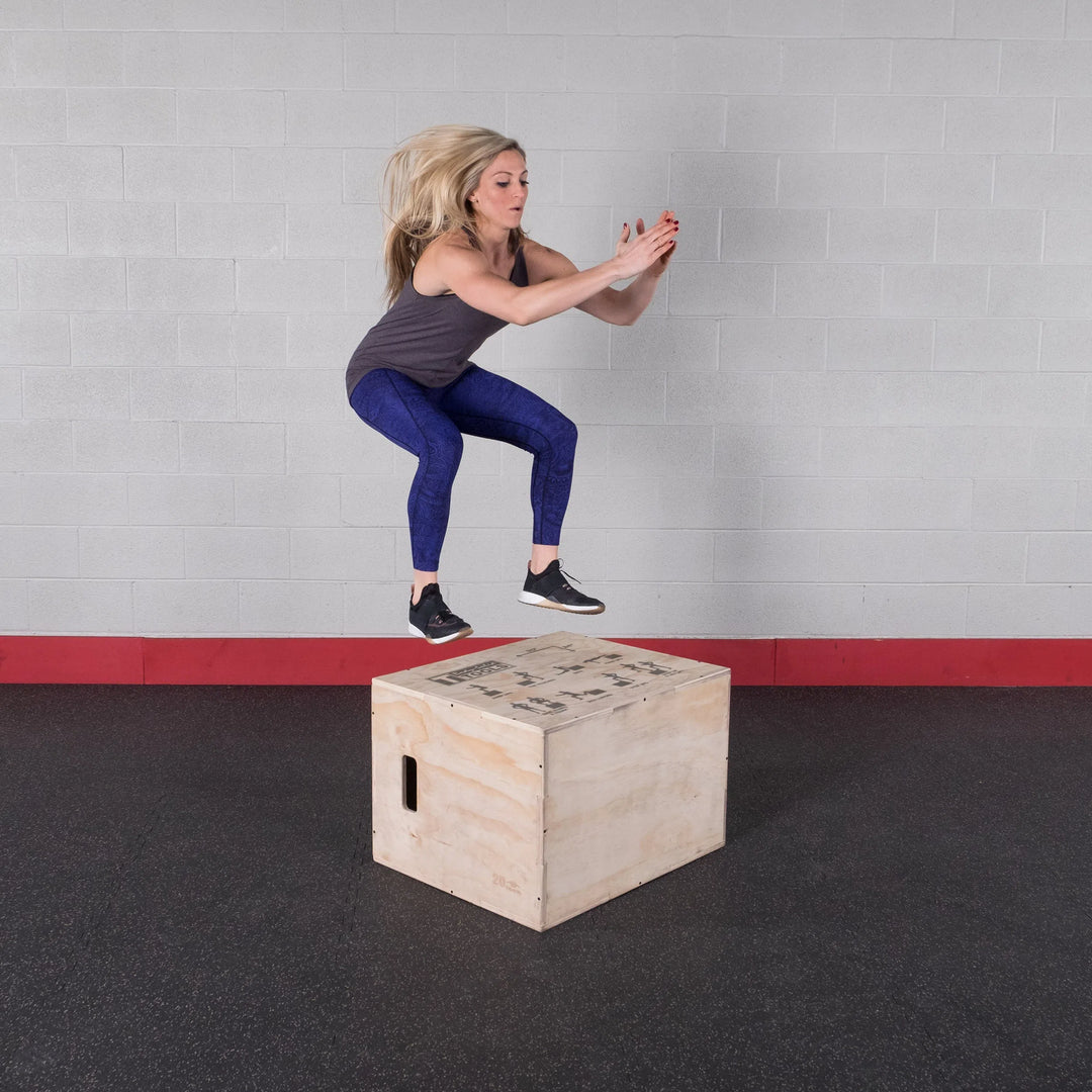 A woman jumping on the Body-Solid Wood Plyo Box BSTWPBOX