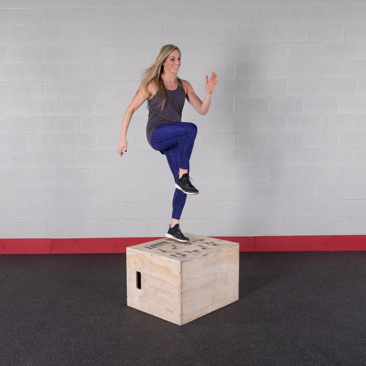 A woman training with the Body-Solid Wood Plyo Box BSTWPBOX
