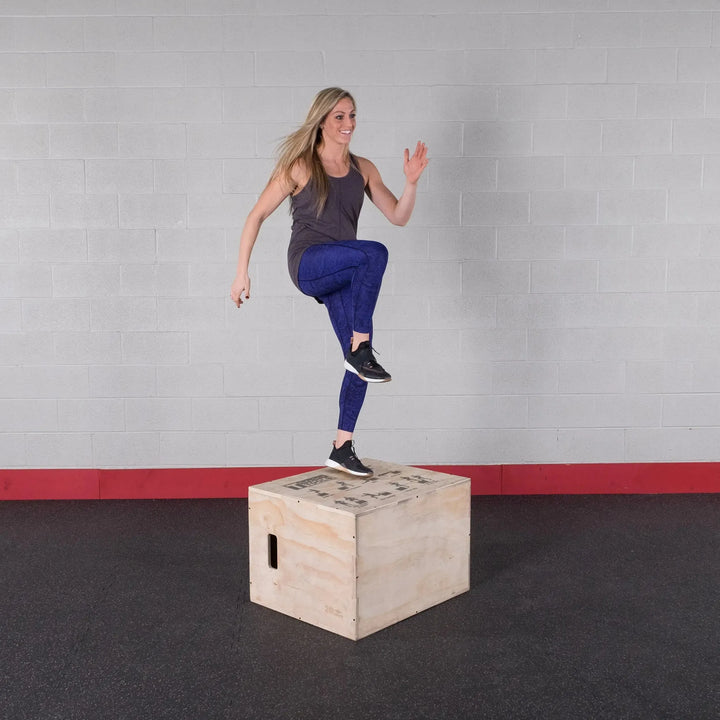 A woman training with the Body-Solid Wood Plyo Box BSTWPBOX