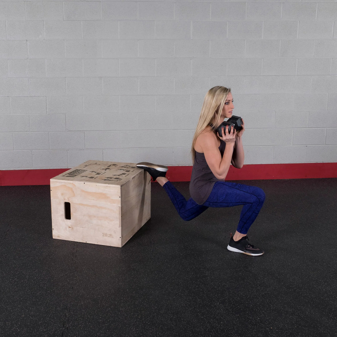 A woman doing lunge on the Body-Solid Wood Plyo Box BSTWPBOX