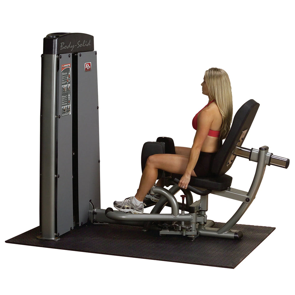 A young woman training on the Body-Solid Inner Outer Thigh Workout Machine DIOTSF
