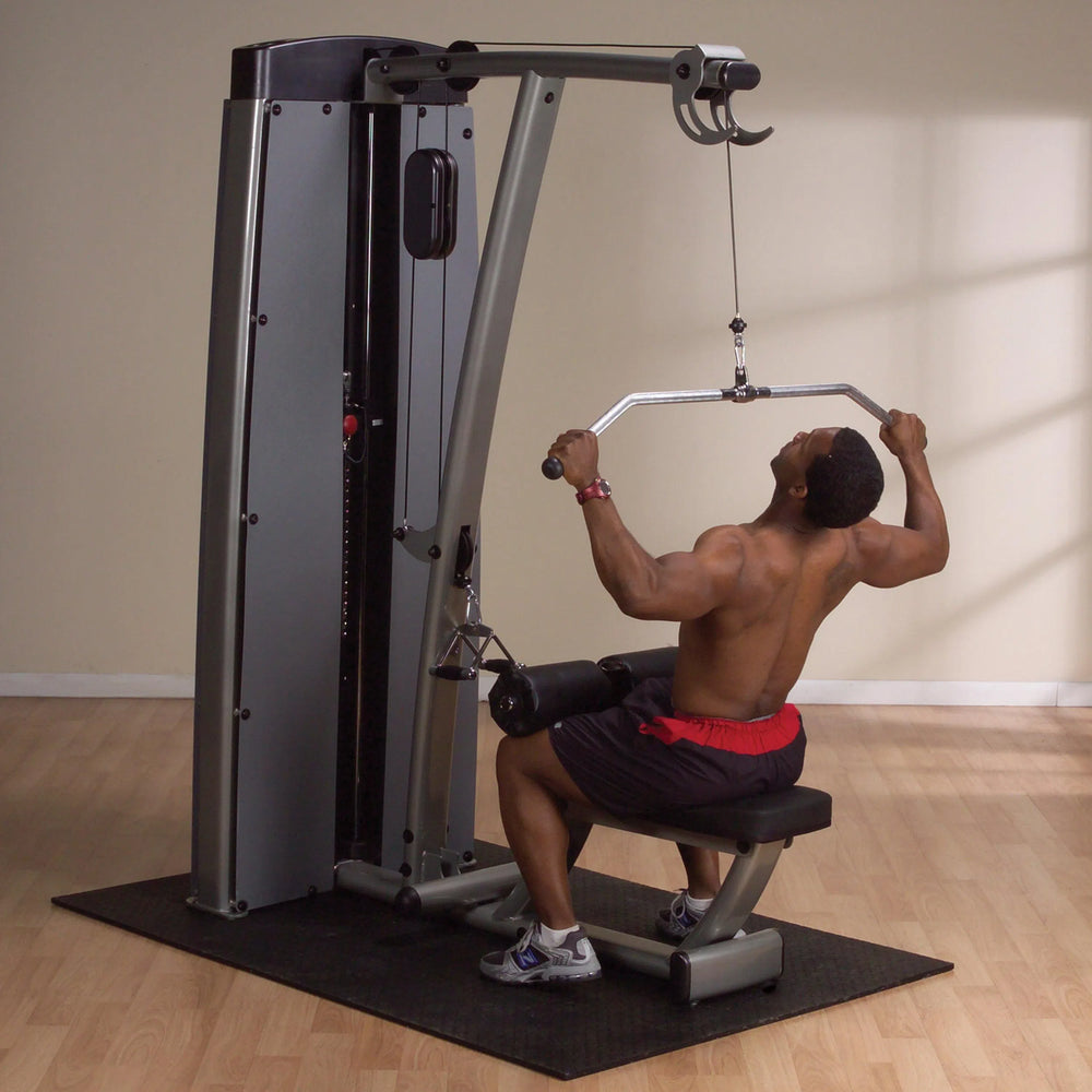 A man training on the Body-Solid Lat Pulldown and Row Machine DLATSF