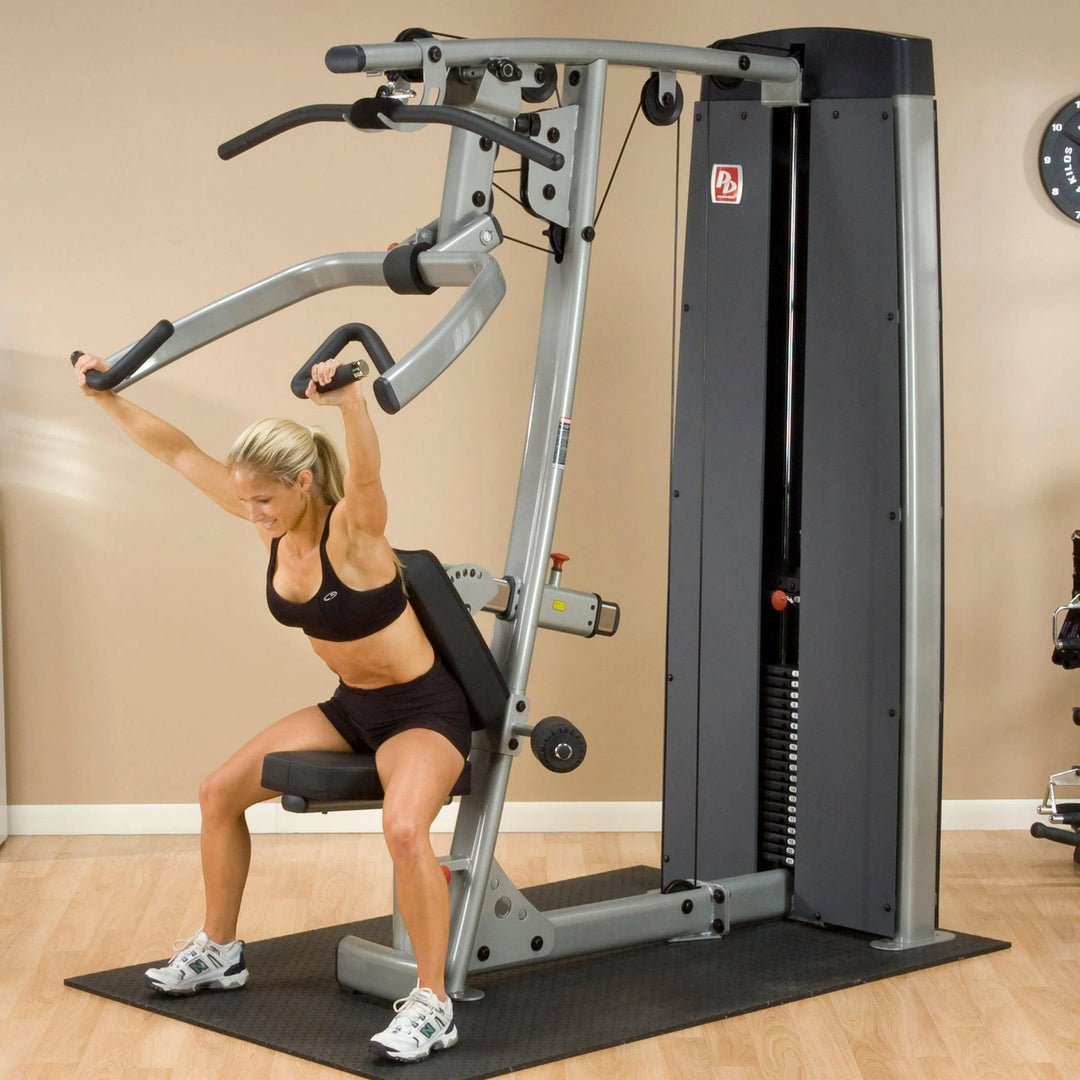 A woman training on the Body-Solid Chest and Back Machine DPLSSF