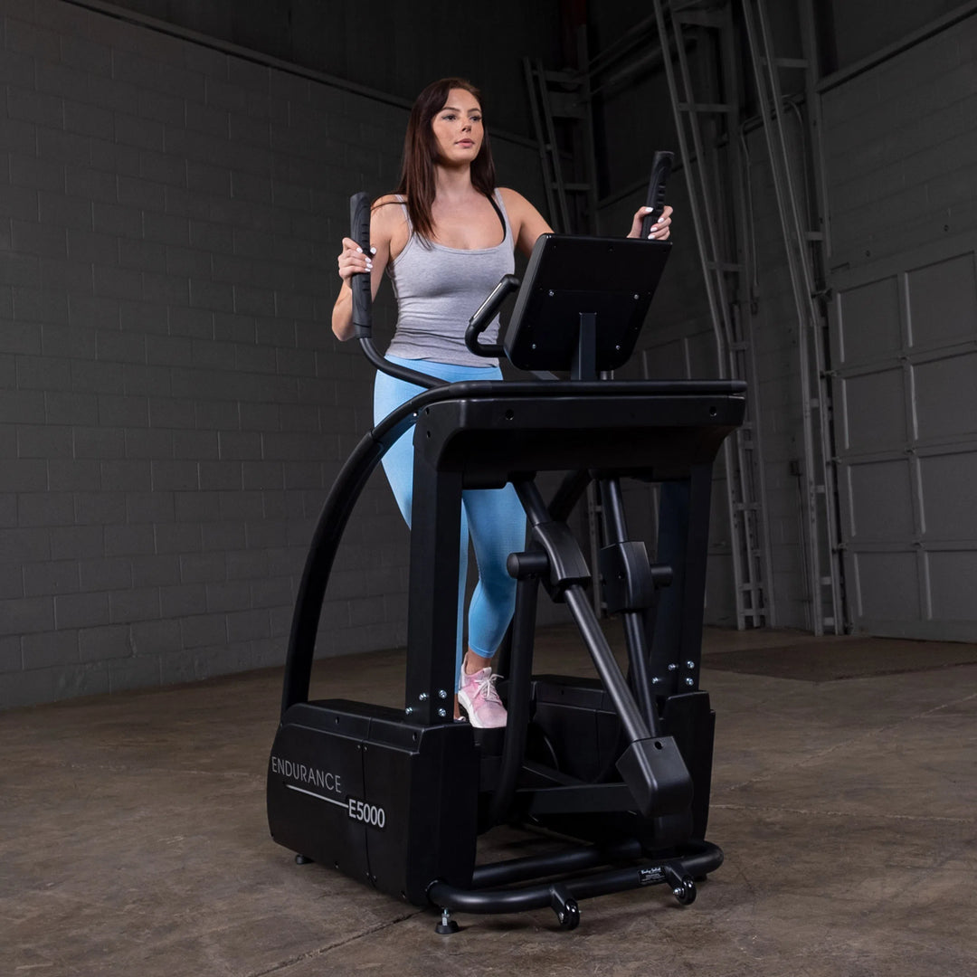 A woman training on the Endurance Commercial Elliptical Machine E5000