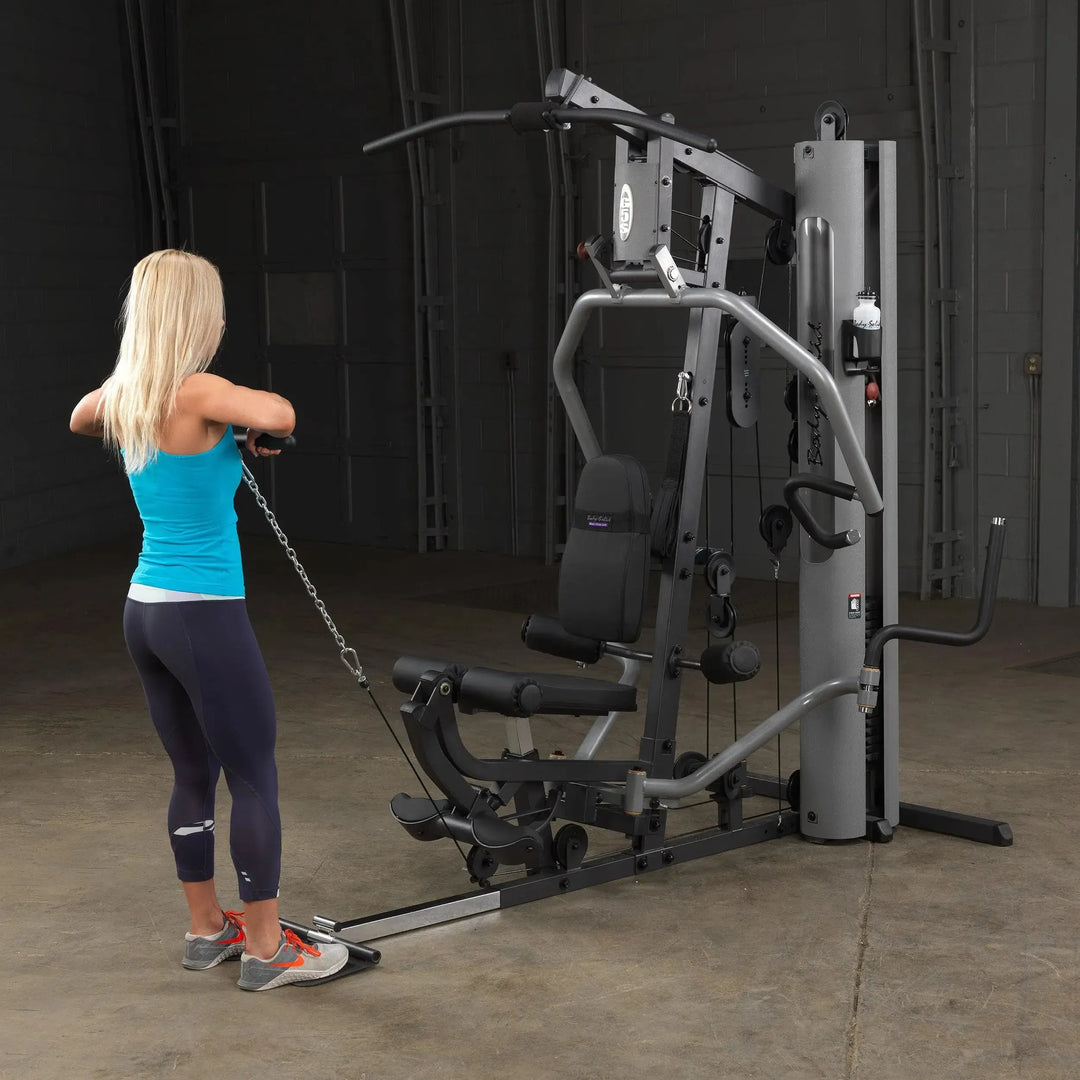 woman high cable pull on Body-Solid Compact Weight Machine G5S