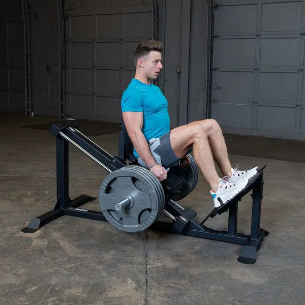 A man training on the Body-Solid Compact Leg Press GCLP100