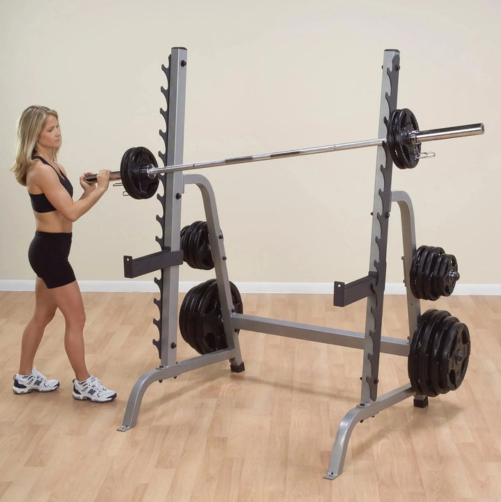 A woman preparing to train on the Body-Solid Squat and Bench Rack GPR370