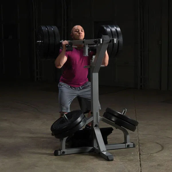 A man training on the Body-Solid Assisted Squat Machine GSCL360