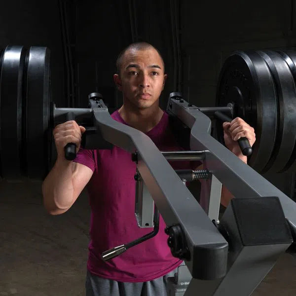 A man training on the Body-Solid Assisted Squat Machine GSCL360
