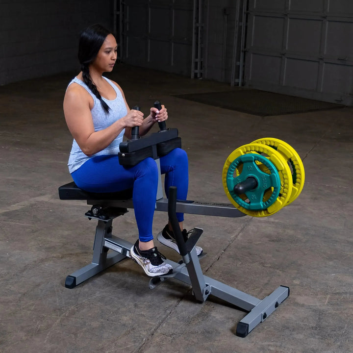 girl seated calf raises exercise on Body-Solid Calf Raise Machine GSCR349