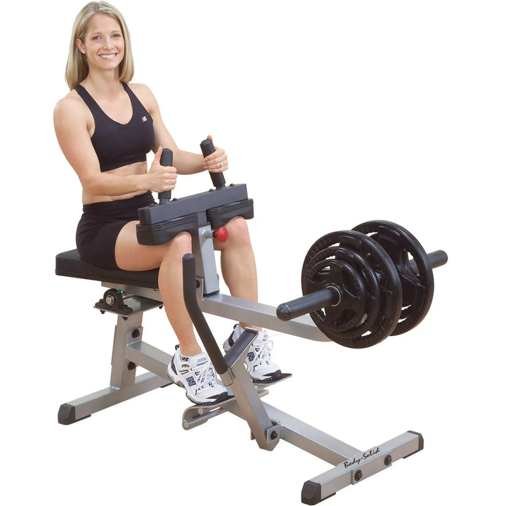 A woman training on the Body-Solid Calf Raise Machine GSCR349