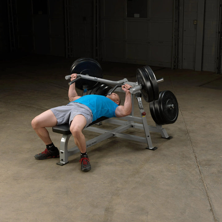 A man training on the Body-Solid Bench Press Machine LVBP