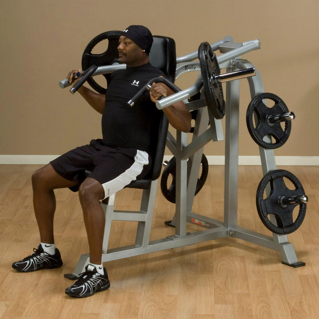 A man training on the Body-Solid Seated Shoulder Press Machine LVSP