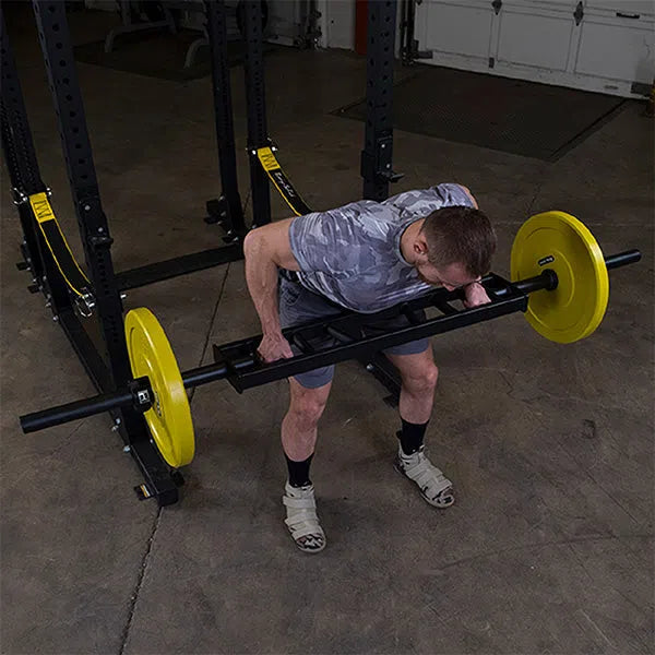 A man training with the Body-Solid Multi Grip Bench Press Bar OMG86