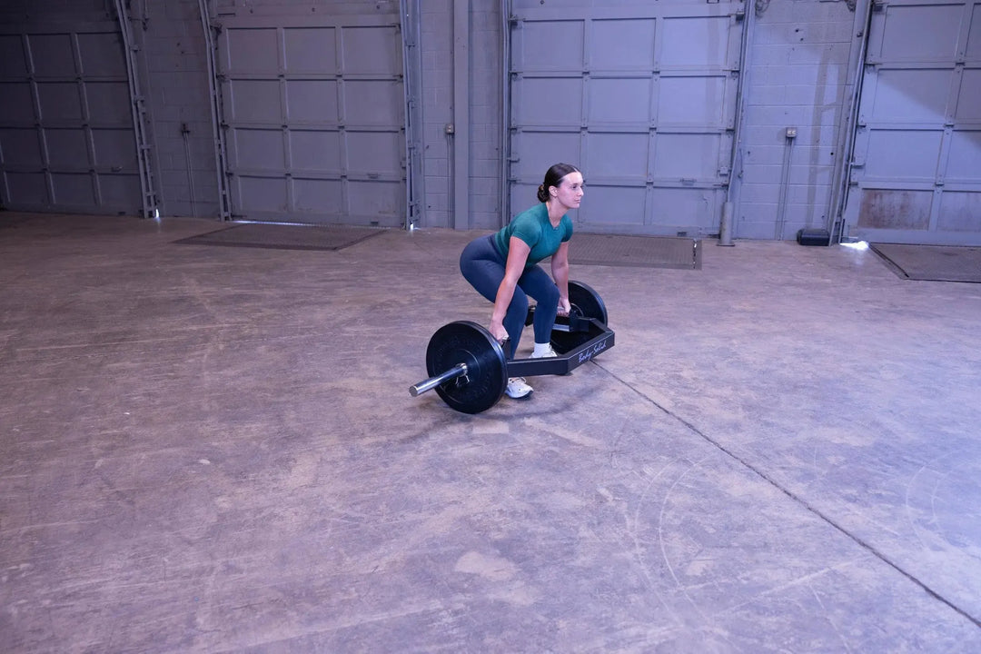 A woman training on the Body-Solid Open Trap Bar OTB100