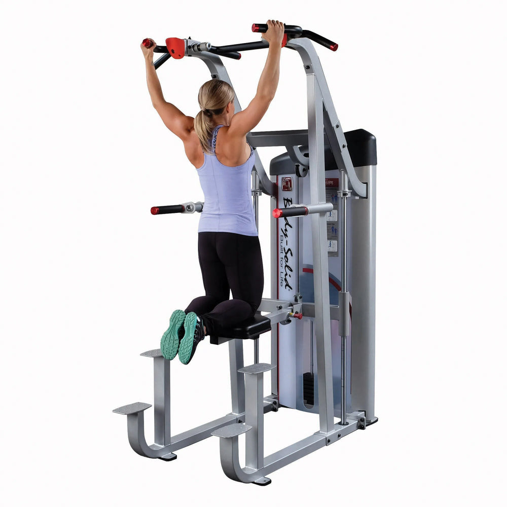 A woman training on the Body-Solid Assisted Pull Up Machine S2ACD