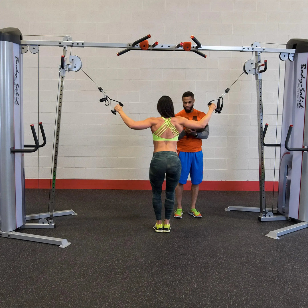 couple training on Body-Solid Commercial Cable Crossover Machine S2CCO