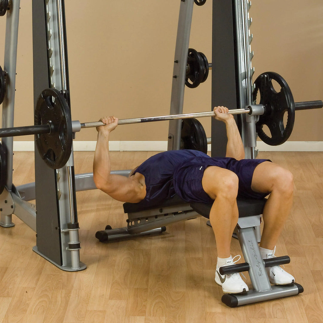 A man doing decline bench presses on the Body-Solid Commercial Smith Machine SCB1000