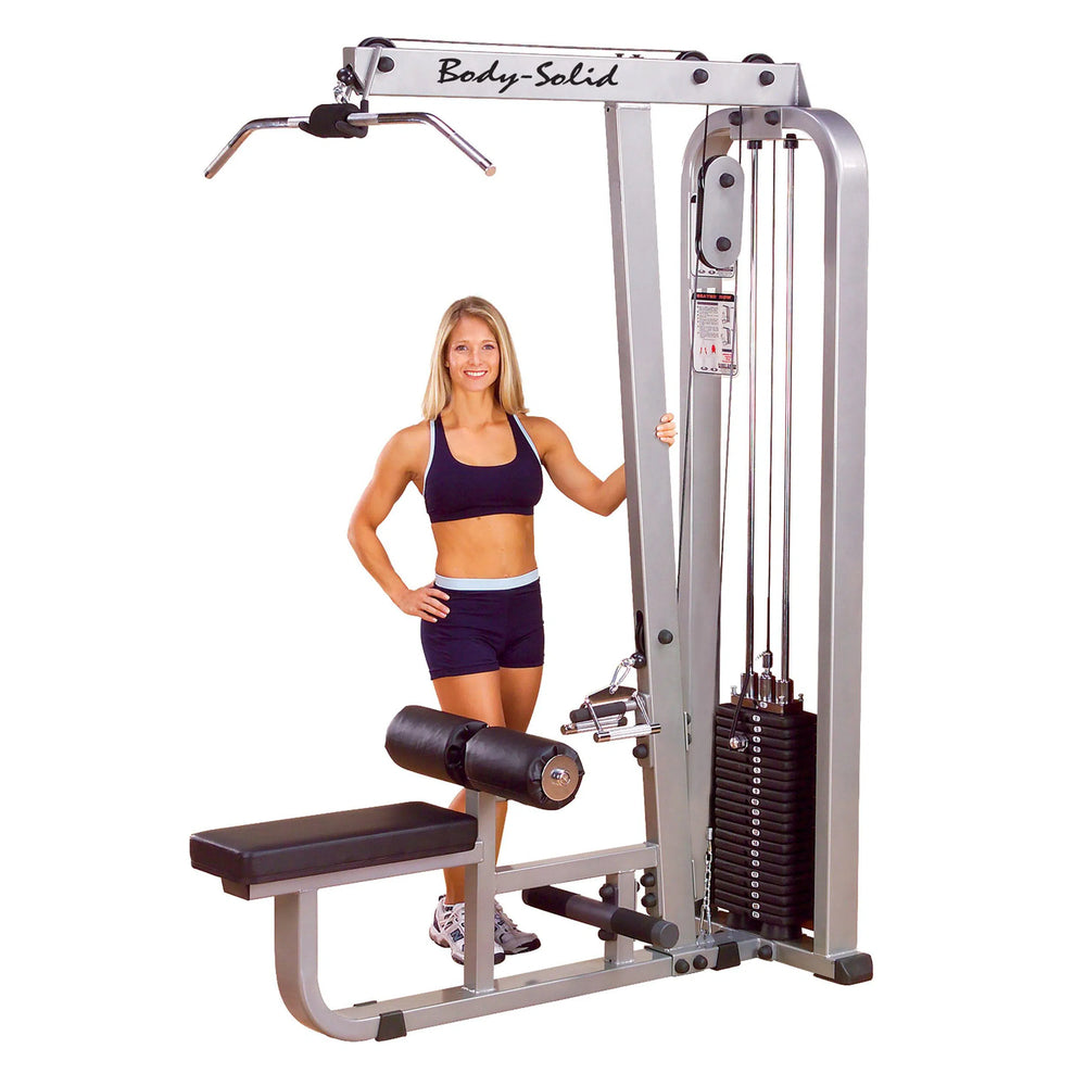 A woman showcasing the Body-Solid Lat Pulldown and Row Machine SLM300G