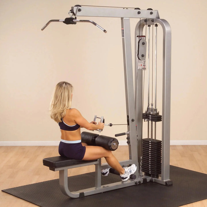 A woman training on the Body-Solid Lat Pulldown and Row Machine SLM300G