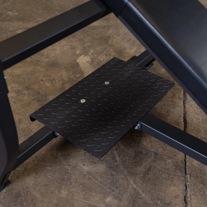 Close-up of a black metal platform with diamond-pattern texture in a gym, part of the Body-Solid Pro Clubline Olympic Incline Bench (SOIB250) on concrete. Ideal for upper body workouts with commercial fitness equipment efficiency.