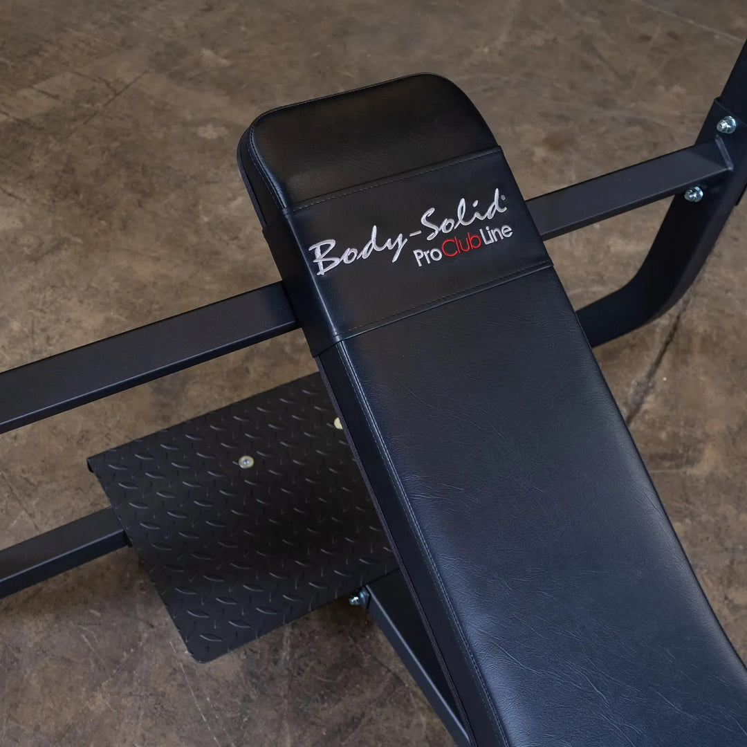 The Body-Solid Pro Clubline Olympic Incline Bench (SOIB250), featuring a sturdy black design with an embroidered backrest, is perfect for upper body workouts. Its firm stance on concrete and diamond-patterned footrest make it a staple in commercial fitness equipment.