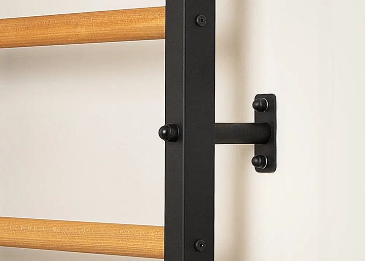Close-up of a BenchK Pro Gym Wall Bars set, featuring the 733 model with light brown bars, mounted on a white wall using black metal brackets. The secure connection highlights multifunctional equipment details.
