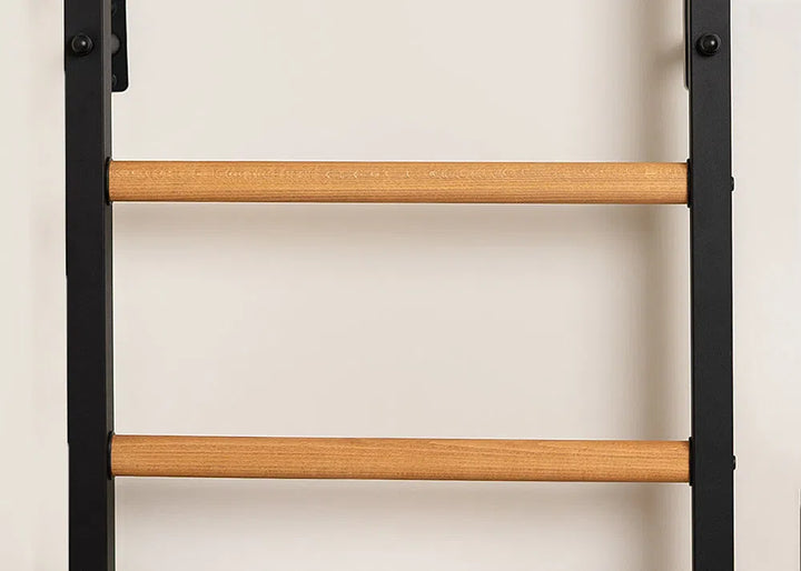 Close-up of a ladder with wooden rungs and black metal sides against a beige wall—it’s the BenchK Pro Gym Wall Bars w/ Bench, Dip & Flex Pull-Up Bar (733), showcasing its multifunctional and versatile design.