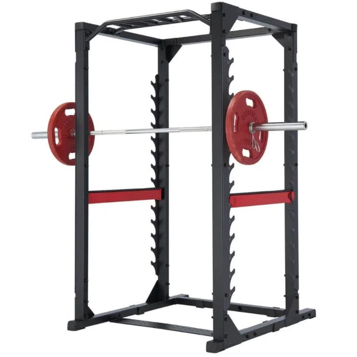 The Steelflex CLPR380 Power Rack is ideal for strength training, featuring a strong metal frame, barbell with red plates, adjustable rungs, a top pull-up bar, side safety bars, and a stable flat base.