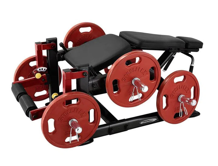The SteelFlex Hamstring Machine (PLLC) by Steelflex is a plate-loaded lying leg curl machine with black padding, four large red Steellux weight plates on each side, and a robust black metal frame for commercial gym performance.