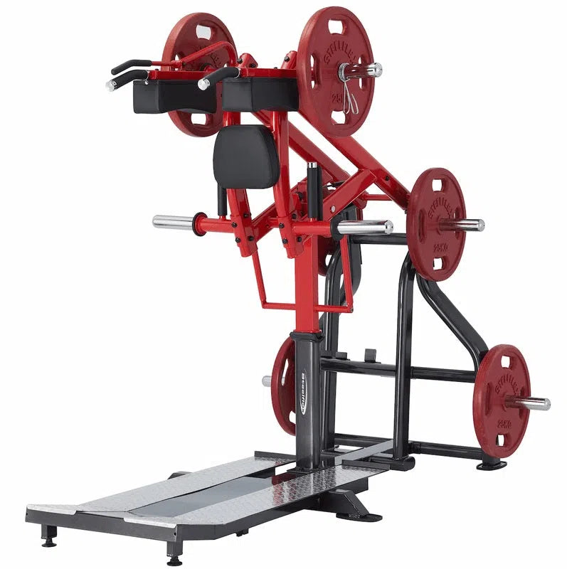 The Steelflex Power Squat Machine (PLSS) features a red and black design with safety enhancements. Its configured for a shoulder press, equipped with weight plates on the arms, an upright seat, and a standing platform.