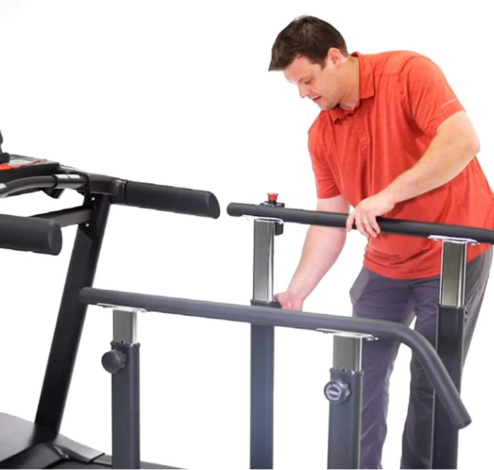 An assistant setting up the HCI RehabMill Seniors Physical Therapy Treadmill RTM