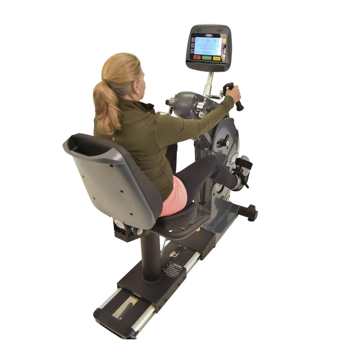 A senior woman training on the HCI PhysioMax Arm Ergometer and Recumbent Bike TBT-1000