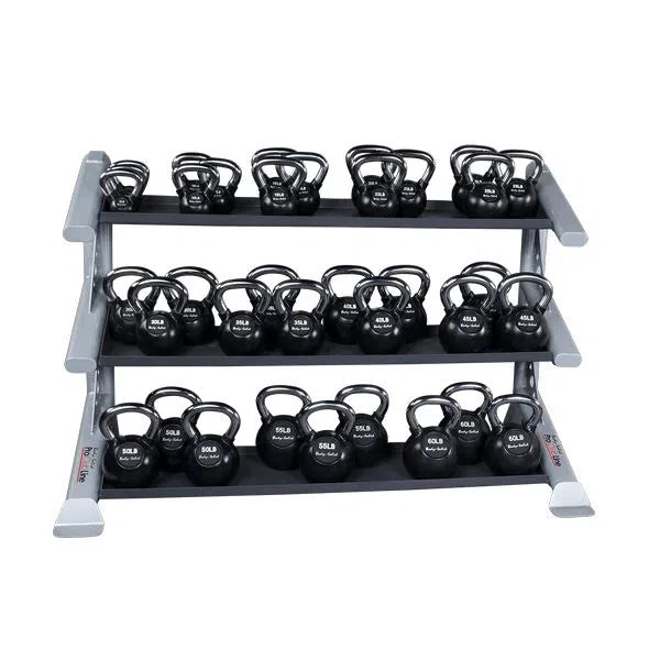 The Body-Solid Pro Clubline Storage Rack with Kettlebell Tiers features a three-tier design, crafted from heavy gauge steel, holding multiple kettlebells labeled in pounds. Its sturdy metallic frame ensures lasting durability and neat organization on the shelves.