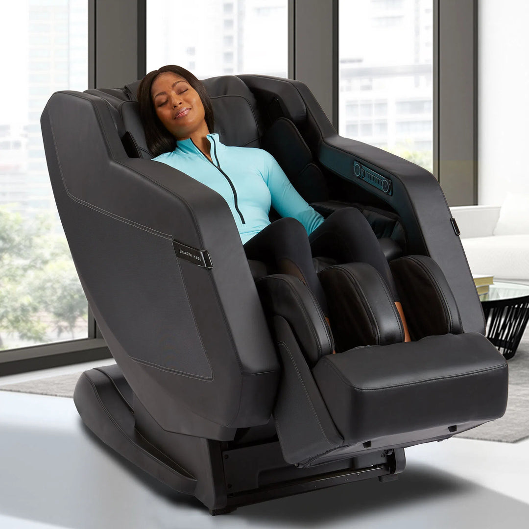 A woman relaxing in the Sharper Image Relieve 3D Full Body Massage Chair 