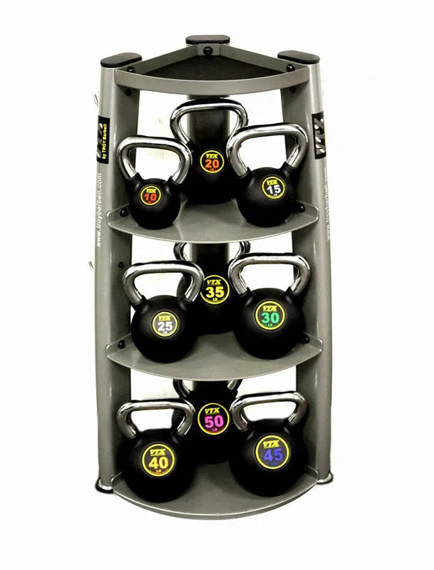 The VTX Kettlebell Set w/ Rack at the fitness center features nine sleek gray kettlebells with vibrant labels. Weights range from 20 to 45, increasing by 5, making it essential gym equipment for diverse workouts.