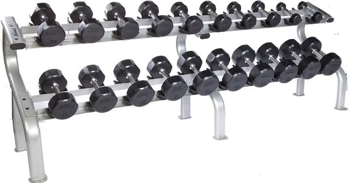 The TROY Barbell 5-50 lb Rubber Commercial Dumbbell Set showcases pairs of black hex dumbbells neatly organized on a sturdy two-tiered metal rack, featuring a silver frame with safety features for secure placement during workouts.