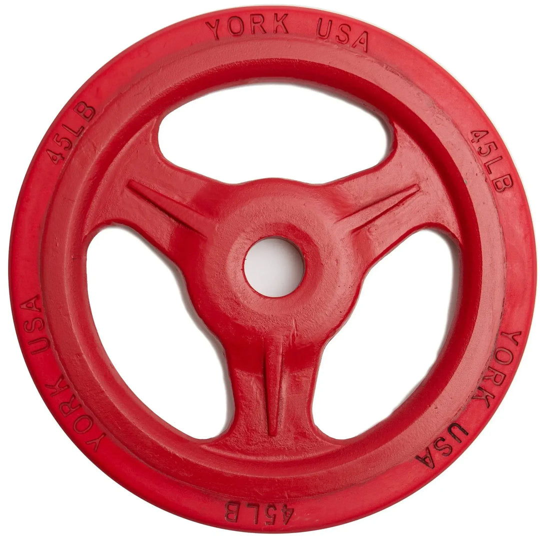 A York Barbell 45-pound red bumper grip plate, part of the York Bumper Grip Plate Set, features YORK USA and 45LB engraved on its edge with three large cutouts for easy handling and a durable rubber rim.