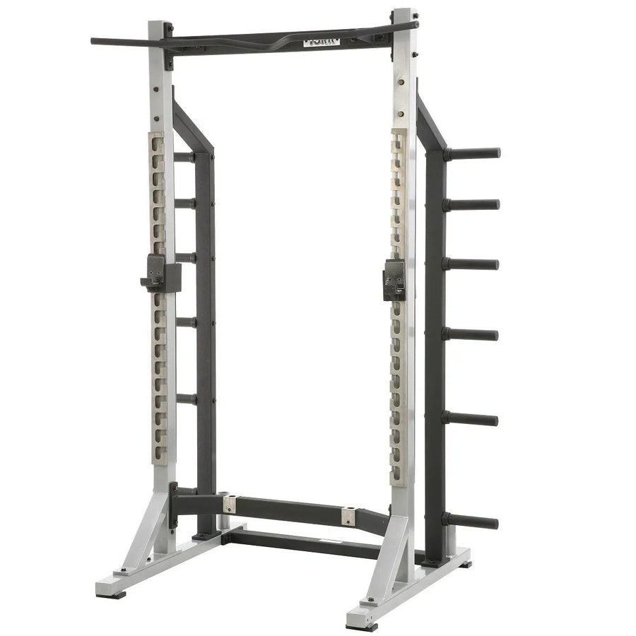 The York Barbell STS Self Standing Half Rack features a sturdy steel frame, pull-up bar, adjustable barbell holders, and side weight storage pegs. Its ideal for strength training with adjustable positions to suit your workout needs.