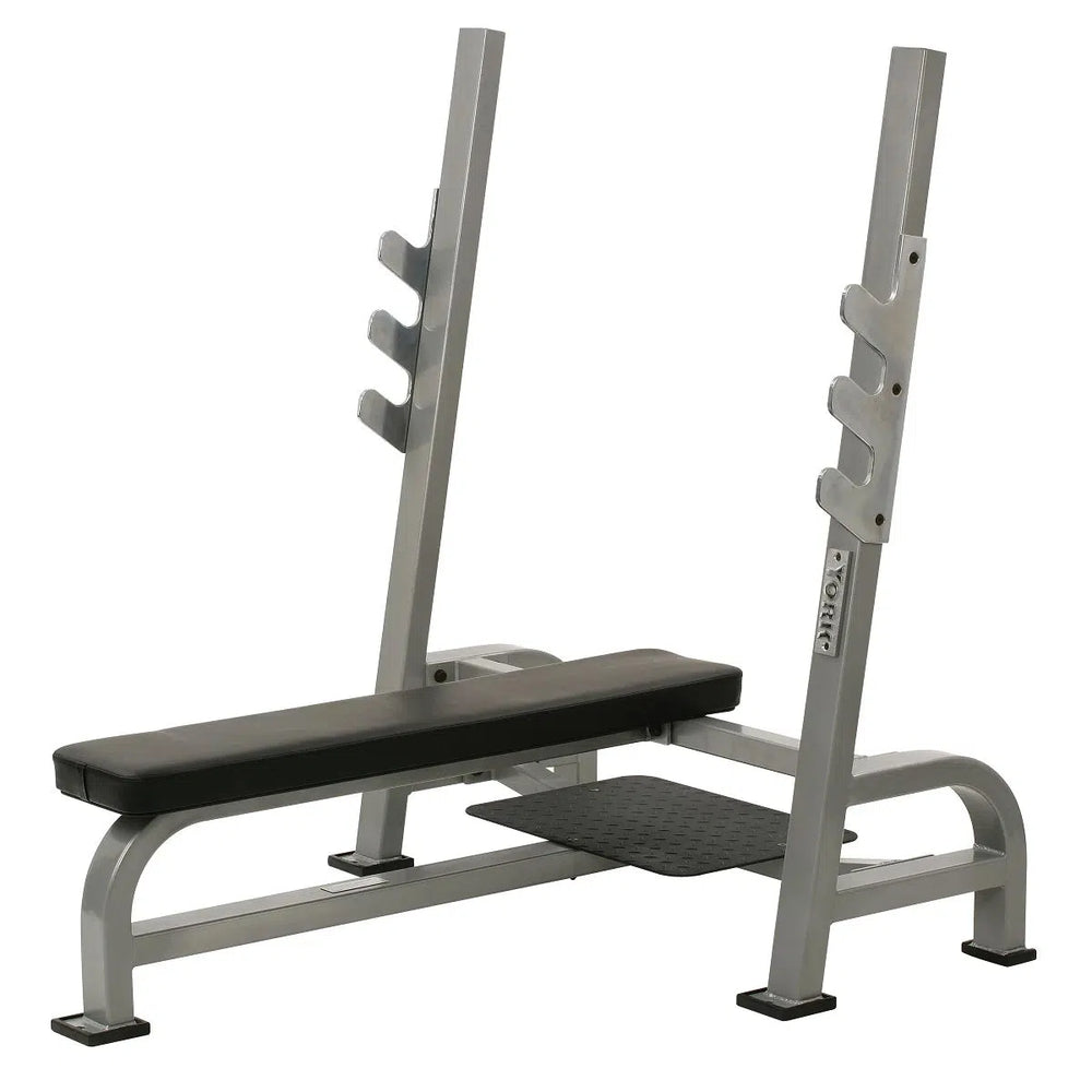 The York STS Olympic Flat Bench Press by York Barbell features heavy contour foam padding, a gray seat and backrest, chrome bar holders, an adjustable hook barbell rack with 3 holders, and a sturdy frame with supportive legs for stability.