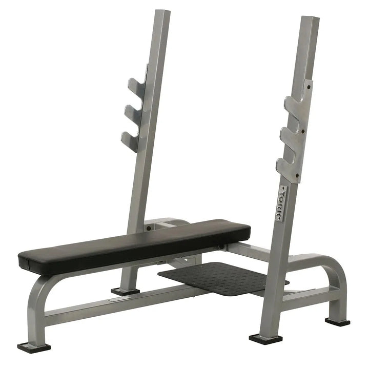 The York STS Olympic Flat Bench Press by York Barbell features heavy contour foam padding, a gray seat and backrest, chrome bar holders, an adjustable hook barbell rack with 3 holders, and a sturdy frame with supportive legs for stability.
