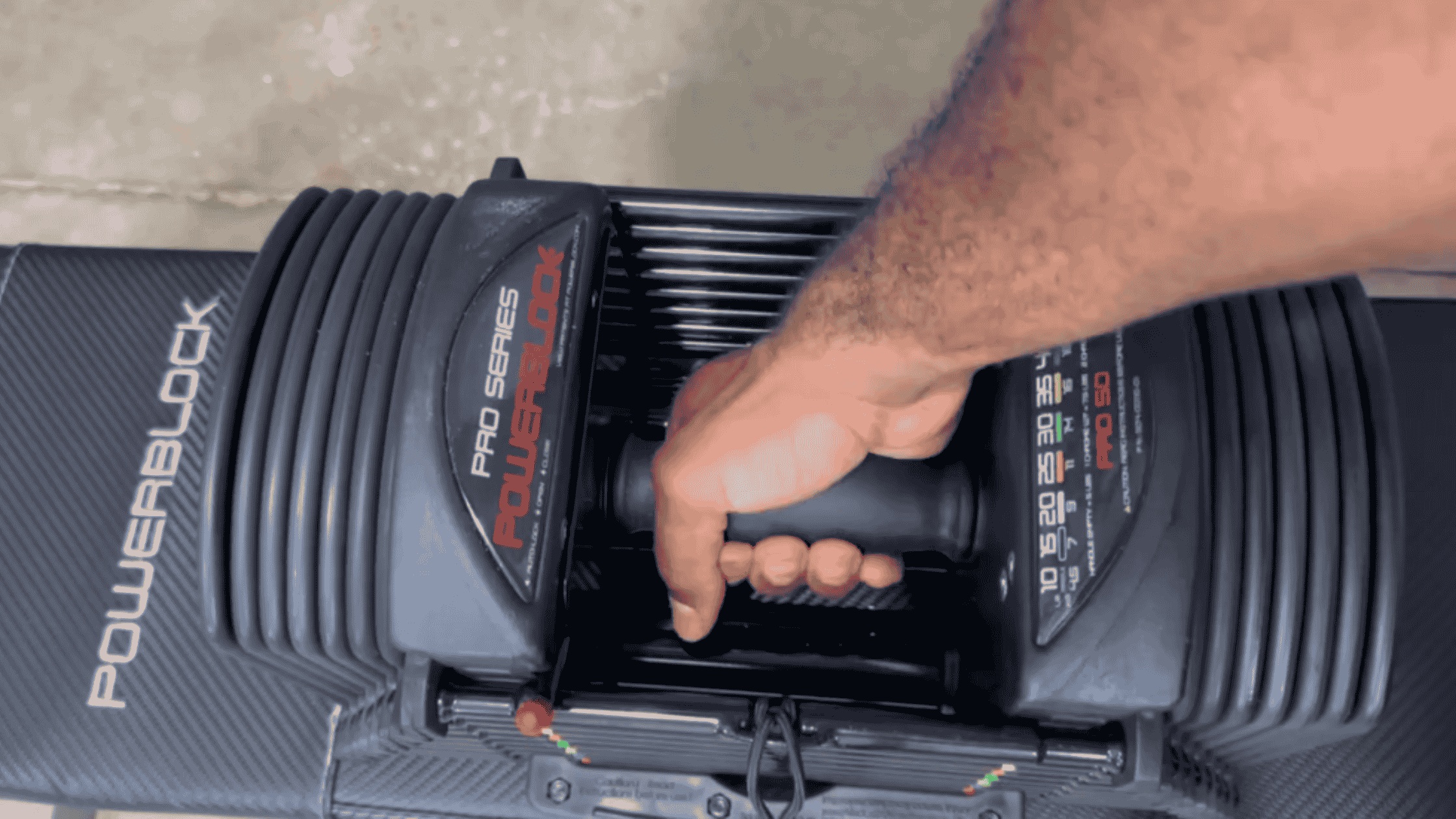 man holding NordicTrack adjustable Dumbbells with handle closeup