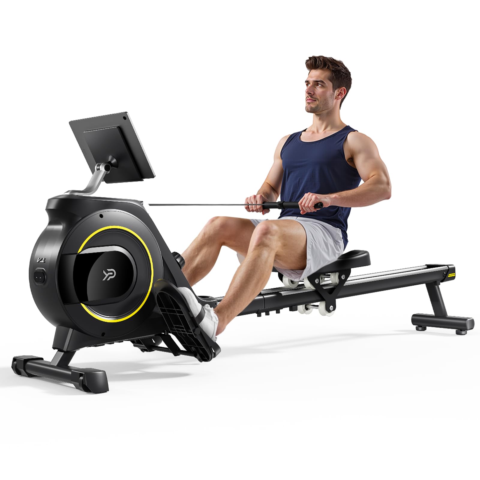 A man in a navy tank top and gray shorts is exercising on a black rowing machine with a digital monitor, pulling the handlebars while seated.