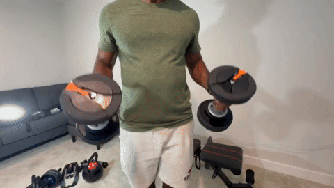male performing bicep curls with the 55 lb. NordicTrack adjustable dumbbells